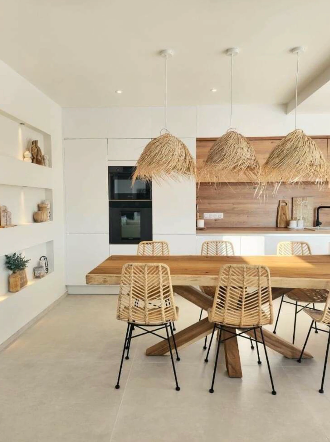 Dining room with three PītasLampas reed ceiling lamps above table.