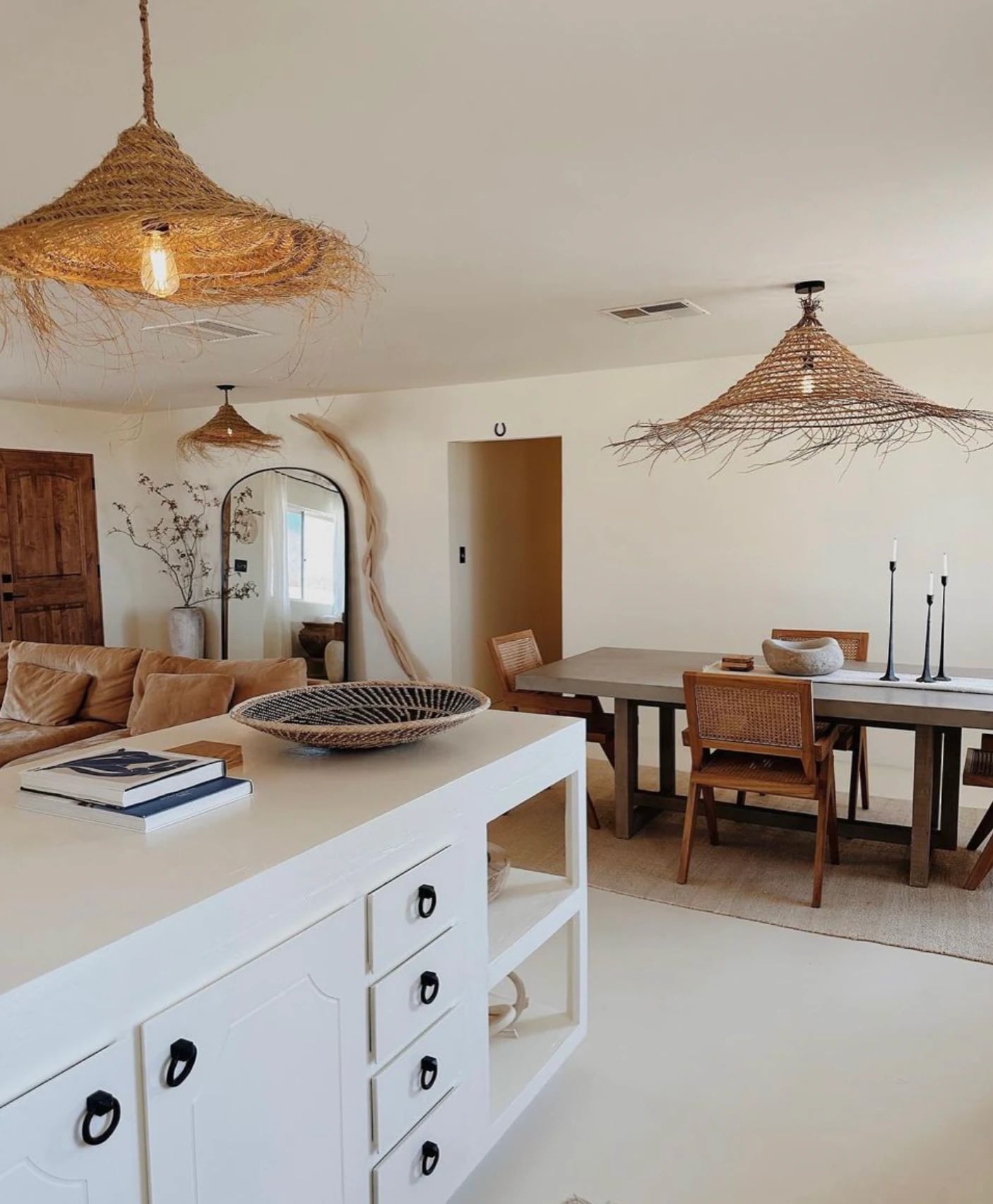 Boho woven ceiling lamps with warm light in living room.