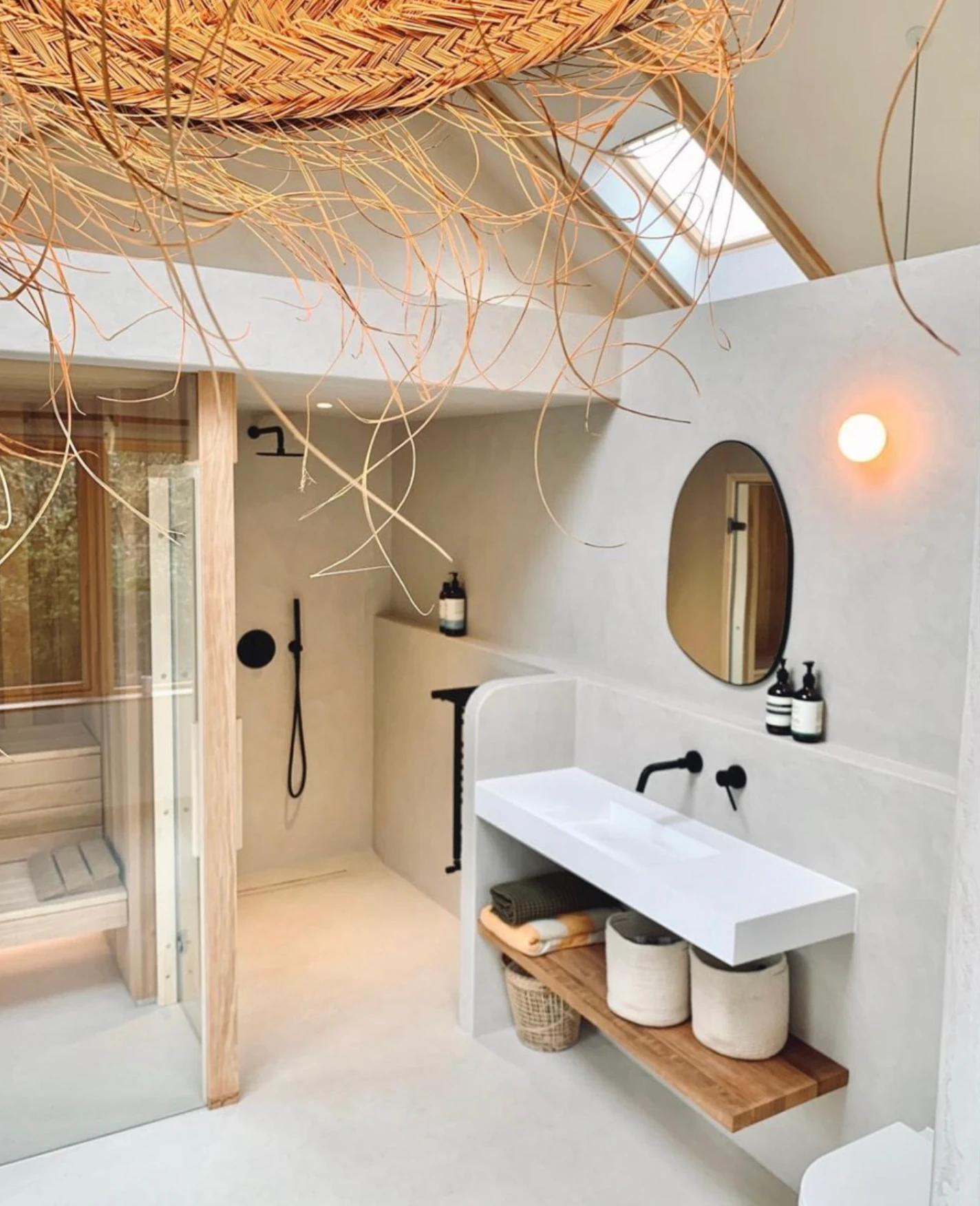 Woven reed ceiling lamp with warm light in a modern bathroom.