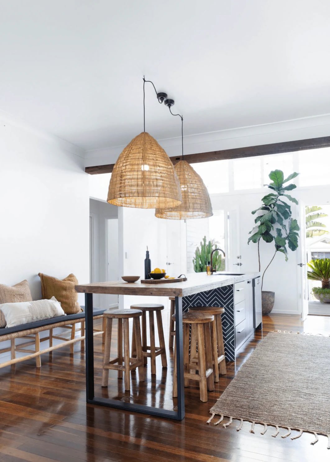 Kitchen with two PītasLampas reed ceiling lamps, warm light.