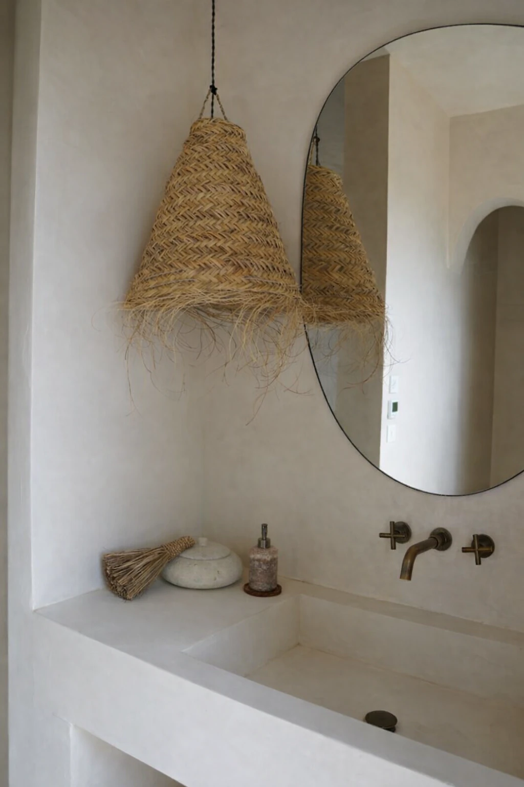 Woven reed ceiling lamp with warm light in a bathroom.