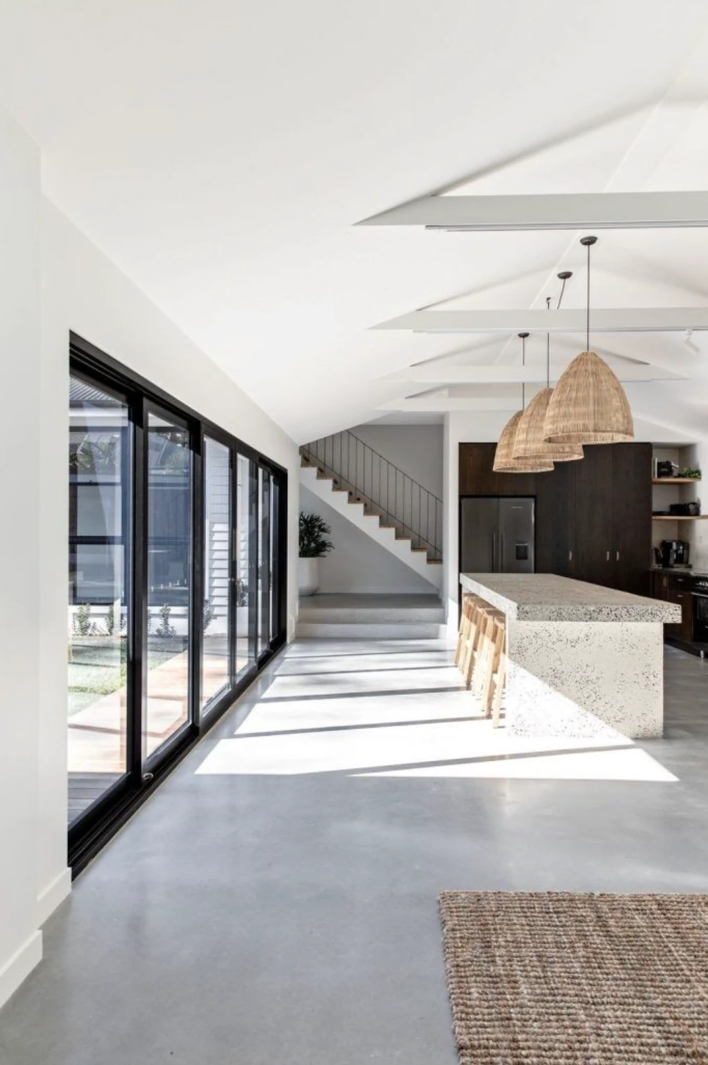 Kitchen with three PītasLampas reed pendant lights above island.